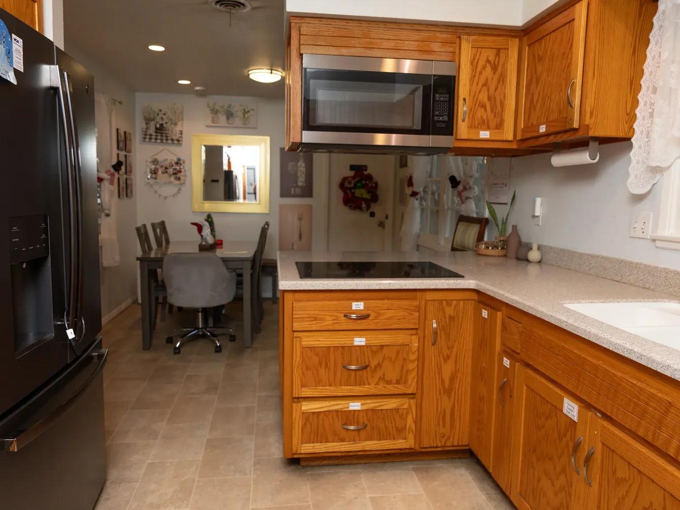 Spacious accessible kitchen with oak cabinets, stainless steel appliances, and adjacent dining area
